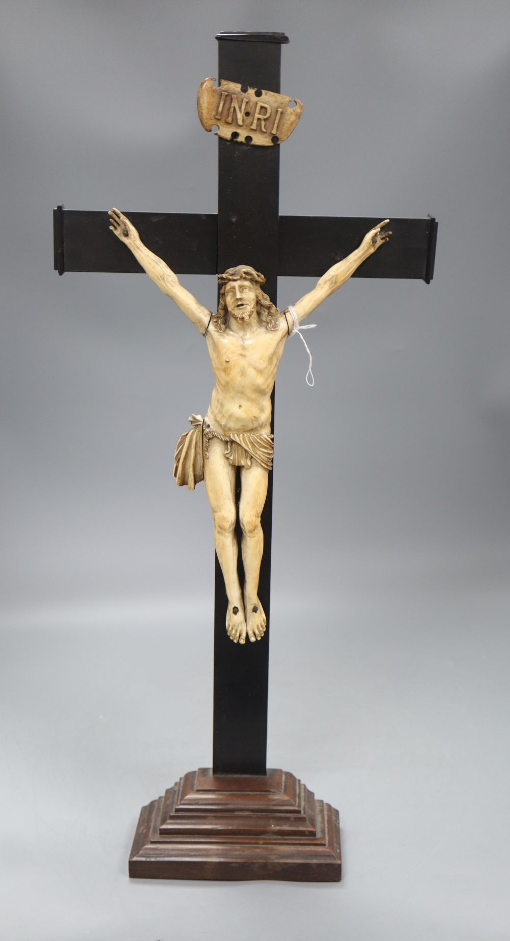 A carved ivory and ebony crucifix, height 59cm